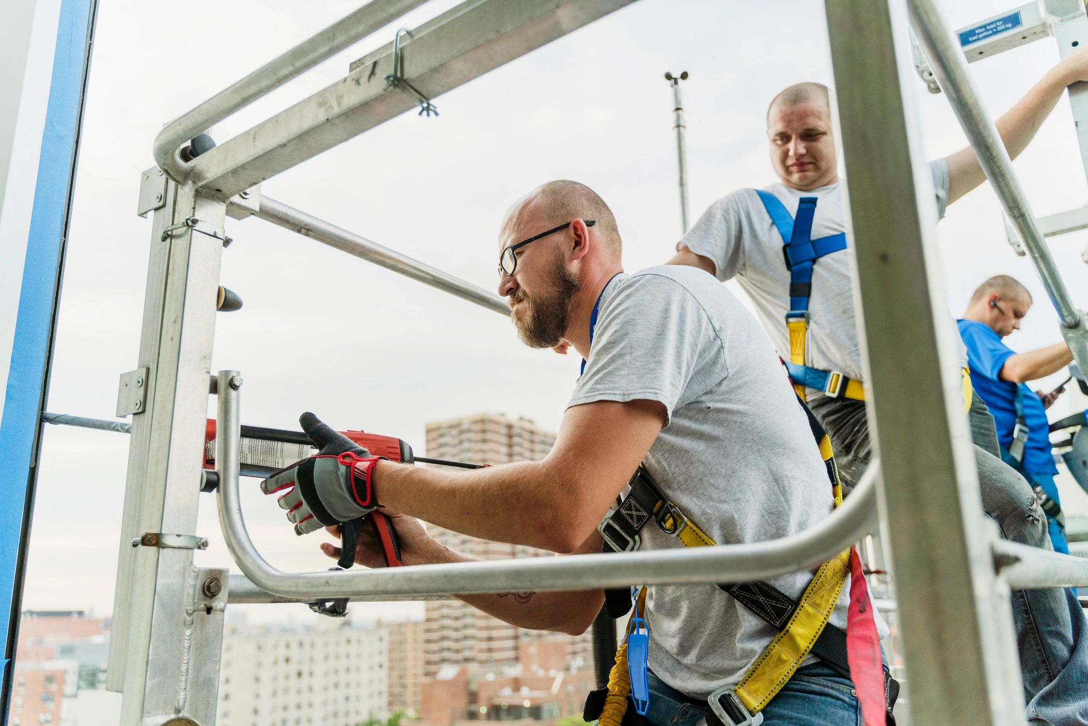 Team applying sealant during glazing installation