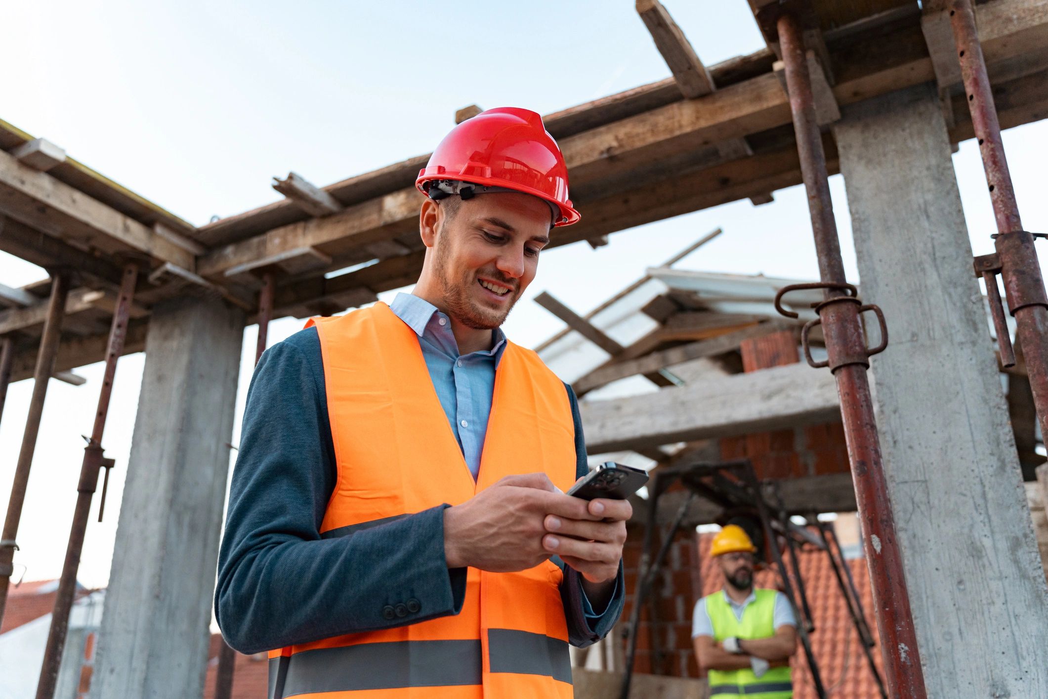 Contractor on a construction site speaking on a phone