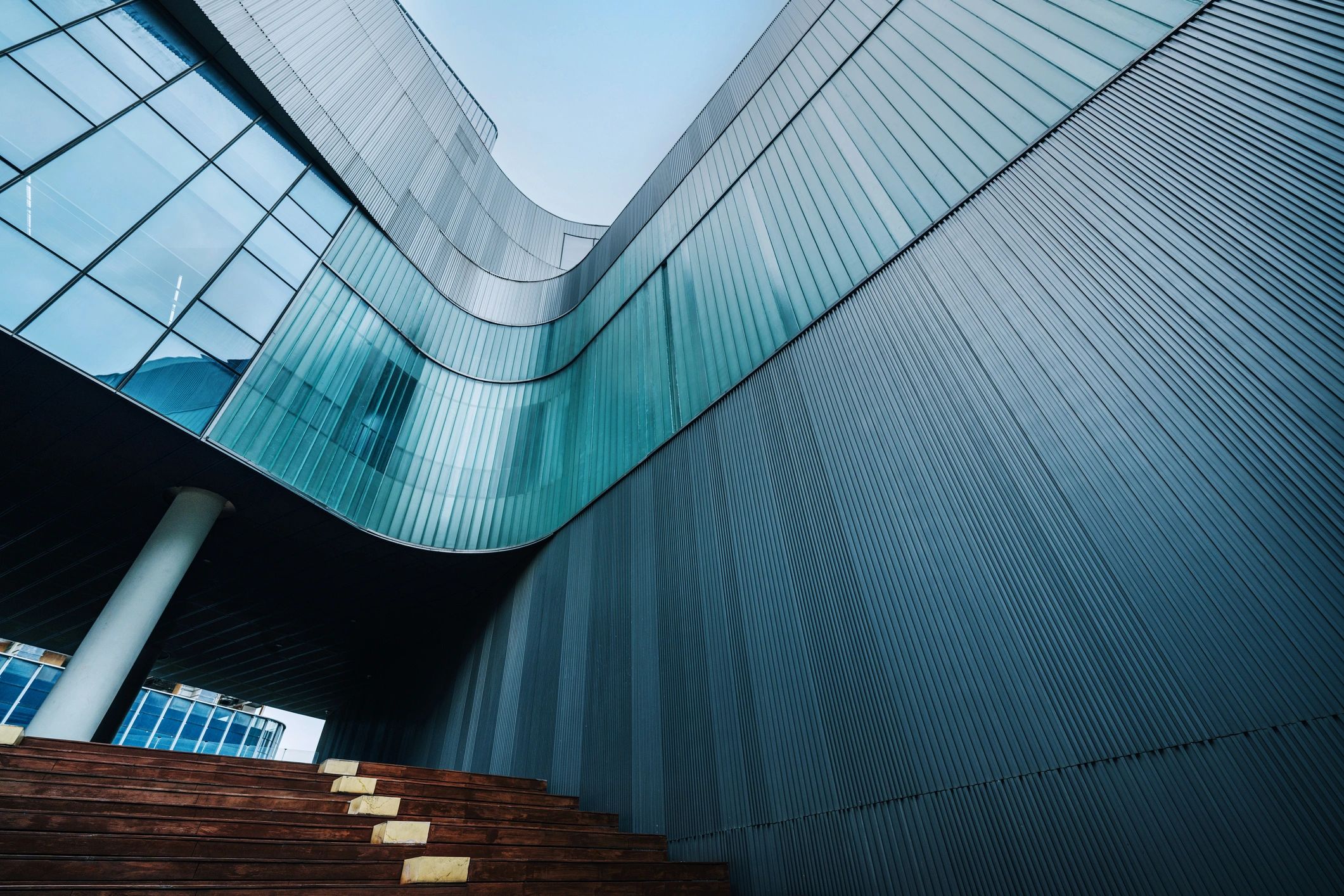 Contemporary building with curved glass and metal siding